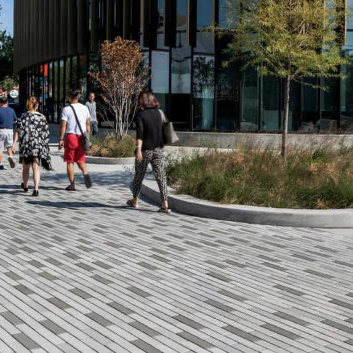 People walking on eco promenade sidewalk